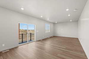 **DISCLAIMER** Interior package & colors may vary. Unfurnished room featuring light wood-style floors and recessed lighting