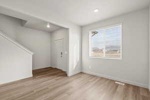 **DISCLAIMER** Interior package & colors may vary. Entrance foyer with light wood-style flooring and recessed lighting