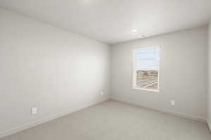 **DISCLAIMER** Interior package & colors may vary. Carpeted empty room with baseboards and recessed lighting