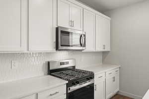 **DISCLAIMER** Interior package & colors may vary.  Kitchen with stainless steel appliances and white cabinets