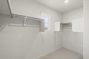 **DISLCAIMER** Interior package & colors may vary. Walk in closet featuring light colored carpet