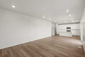 **DISLCAIMER** Interior package & colors may vary. Unfurnished living room featuring recessed lighting and light wood finished floors