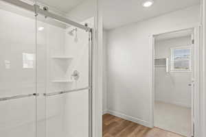 **DISLCAIMER** Interior package & colors may vary. Bathroom featuring a stall shower, light wood-style flooring, and recessed lighting