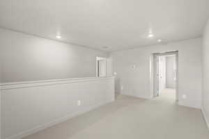 **DISLCAIMER** Interior package & colors may vary. Empty room featuring light colored carpet and recessed lighting