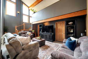 Living area with a high ceiling and carpet floors