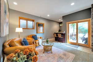 Living area featuring a bar and recessed lighting