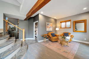 Living area featuring stairs and recessed lighting