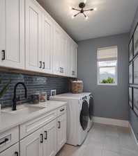Laundry room with separate washer and dryer, cabinet space, light tile patterned floors, a textured ceiling, and suspended lighting