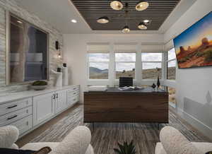 Office area featuring dark wood-style floors