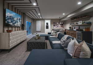 Carpeted cinema room with recessed lighting and wine cooler