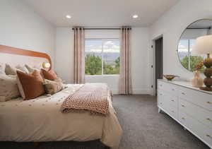 Bedroom with dark carpet, recessed lighting, and a mountain view