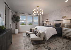 Bedroom with a barn door, a mountain view, light wood-type flooring, hanging lights, and wallpapered walls