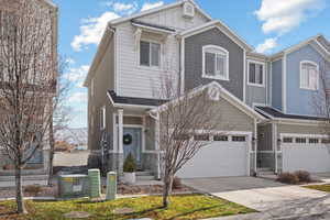 View of front of house featuring board and batten siding, concrete driveway, and an attached garage