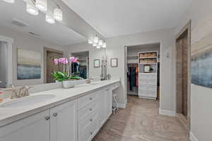 Beautiful master bath with oversized walk in shower, double vanity, and a spacious closet with custom built-in’s