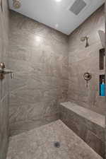 Amazing tiled shower with alcoves for products and a full bench for comfort.
