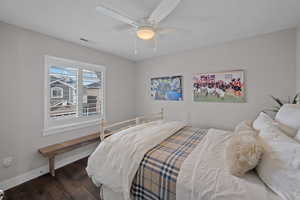 Bedroom 2, same beautiful hardwood with a ceiling fan, and custom closet