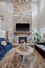 22 ft, floor to ceiling natural Stone fireplace with custom mantel and hearth