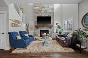 Living room with natural stone gas fireplace, open to upper floor