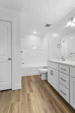 Full bathroom featuring vanity, light wood-style floors, and shower / bath combination