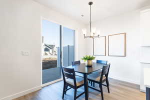 Dining space with light wood-style flooring and a chandelier