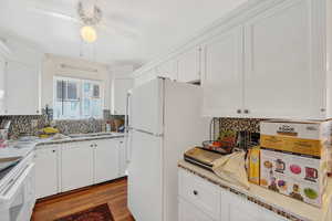 Kitchen with white cabinets and hardwood