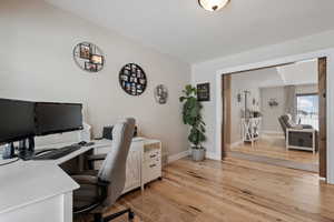 Spacious office with views out to the front of the home. Lovely hardwood flooring. Built-in cabinetry is included. Barn style doors.