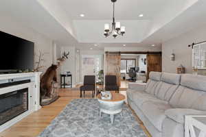 Main Level Living! High Quality 3/4" Hard wood flooring throughout main areas. Vaulted Ceilings. Can lights. Generous slider for abundant natural light. Looking at the front door. Barn style doors lead to the office/den.