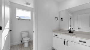Bathroom with vanity and light wood-style flooring