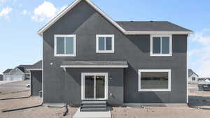 View of front of home featuring roof with shingles, stucco siding, and entry steps