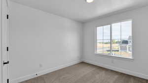 Carpeted empty room with baseboards