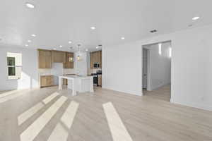 Unfurnished living room with recessed lighting and light wood-type flooring