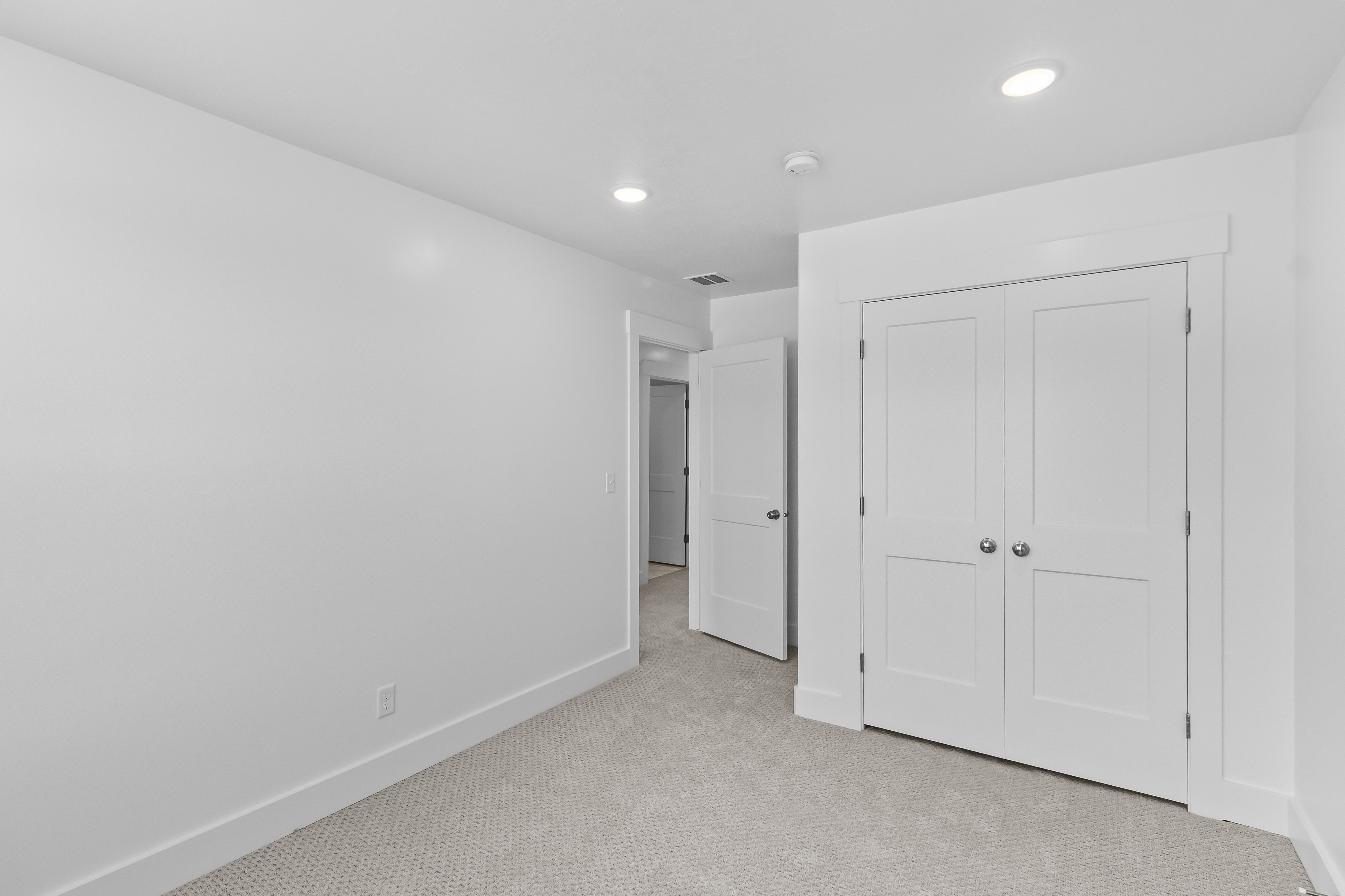 Unfurnished bedroom featuring carpet flooring, a closet, and recessed lighting
