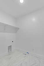 Laundry area featuring baseboards and hookup for an electric dryer