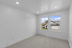 Unfurnished room featuring carpet flooring, recessed lighting, and a mountain view