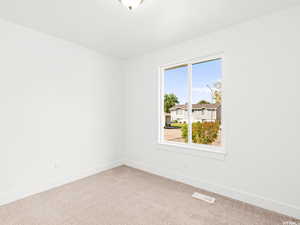 Unfurnished room with carpet and baseboards