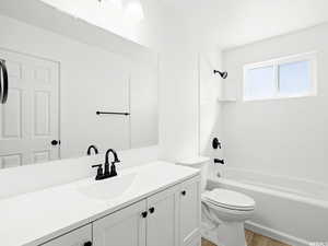 Bathroom featuring vanity, tub / shower combination, and light wood-style flooring