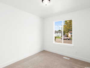 Unfurnished room featuring carpet and baseboards