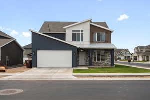 Contemporary house with concrete driveway, a porch, a shingled roof, an attached garage, and a residential view