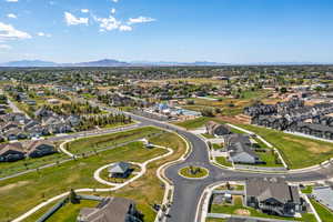 Aerial view of property and surrounding area with nearby suburban area and mountains