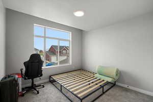 Bedroom featuring carpet floors and baseboards