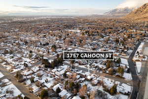 Snowy aerial view with a residential view and a mountain view
