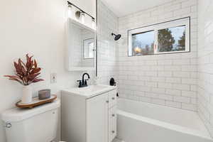 Full bath featuring vanity and bathing tub / shower combination