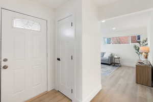 Foyer featuring light wood-type flooring and recessed lighting