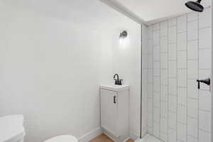 Bathroom featuring vanity and a shower stall