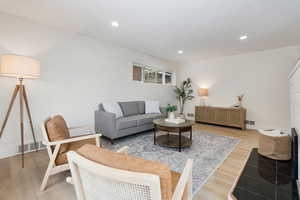 Living room featuring light wood finished floors and recessed lighting