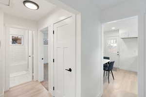 Hall featuring light wood-style flooring and baseboards
