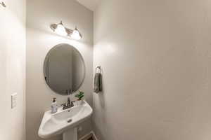 Bathroom featuring a sink and a textured wall