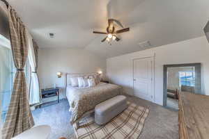 Carpeted bedroom with a ceiling fan and baseboards