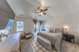 Carpeted bedroom with a ceiling fan and access to exterior