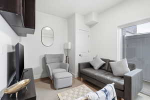 Living area with baseboards and light wood finished floors
